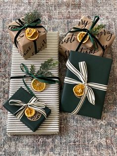 three wrapped presents with orange slices on them