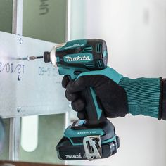 a person holding a drill in their hand