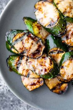 grilled chicken and peppers on a gray plate with a white towel in the background