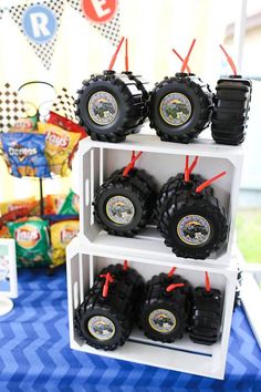 there are many toy trucks that are on the shelves in front of each other at this birthday party