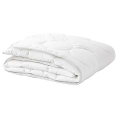 the white comforter is folded on top of each other