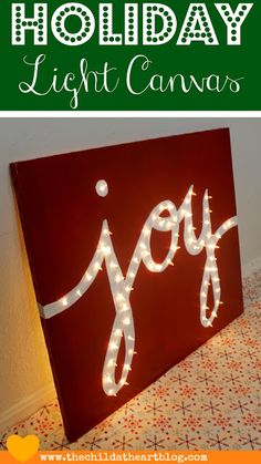 a holiday light canvas with the words joy on it