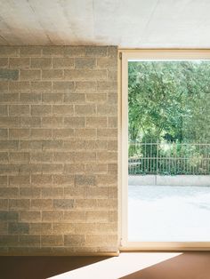 an open window in a room with brick walls