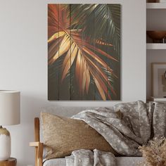 a living room scene with focus on the couch and palm leaf painting hanging above it