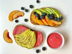 an avocado, peaches, and blueberries sandwich with fruit on it