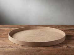 a round tray sitting on top of a wooden table