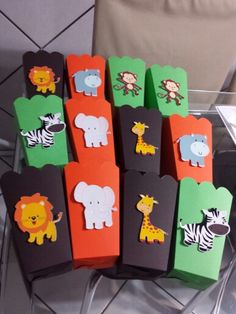 there are many small tags with animals on them in the shape of elephants, zebras and giraffes