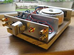 two audio equipment sitting on top of a wooden table