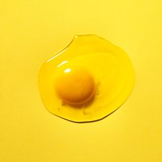 an egg yolk on a yellow surface