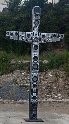 a large metal cross with speakers on it