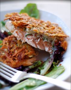 a white plate topped with food and a fork