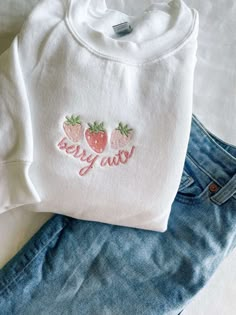 The Berry Cute Strawberry Embroidered Sweatshirt is a delightful addition to your wardrobe, exuding charm and style. This 2D crewneck sweatshirt showcases a captivating all-over print of luscious strawberries, adding a playful and vibrant touch to your outfit. Designed for both women and men, this sweatshirt, with its unique features and undeniable comfort, is a must-have for fashion enthusiasts. One of the standout features of this sweatshirt is its exquisite embroidery of strawberries. The met Iron On Crewneck Ideas, Cute Embroidery Crewneck, Embroidered Crewneck Aesthetic, Cute Embroidery On Clothes, Cute Embroidered Sweatshirt, Cute Cricut Shirts, Embroidered Sweatshirt Ideas, Embroider Sweatshirts, Embroidery Sweatshirt Ideas