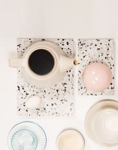 a white table topped with plates and cups