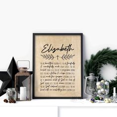 a framed print with the words elizabeth on it next to christmas decorations and other items