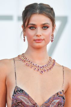 the actress wearing an elaborate necklace and earrings is seen on the red carpet at the 76th