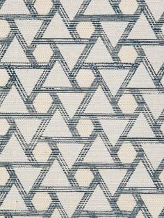 a blue and white rug with triangles on it