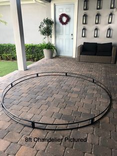 a patio with brick pavers and a wreath on the wall