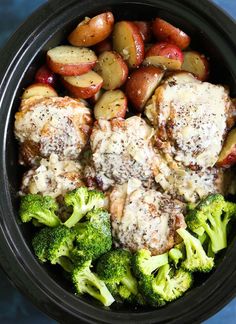 a bowl filled with meat, potatoes and broccoli