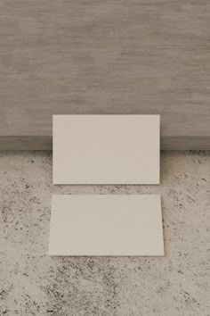 two pieces of white paper sitting on top of a counter