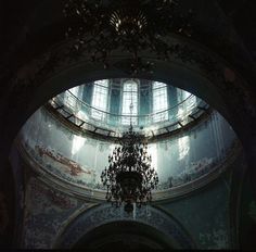 a chandelier hanging from the ceiling in a church