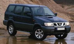 a black suv is parked in the mud