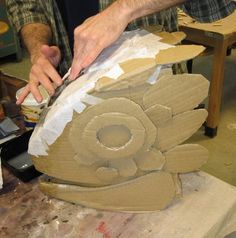 a man working on a sculpture in his studio