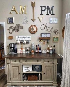 a kitchen island with lots of signs on the wall above it and a coffee bar