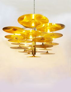 a chandelier with yellow lights hanging from it's sides in a room