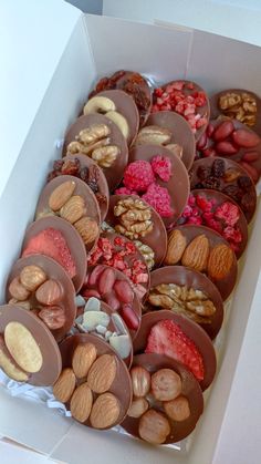 a box filled with lots of different types of nuts and chocolates on top of each other