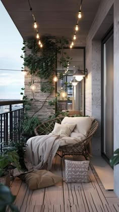 a balcony with plants and lights on the ceiling, along with a chair that is covered by a blanket