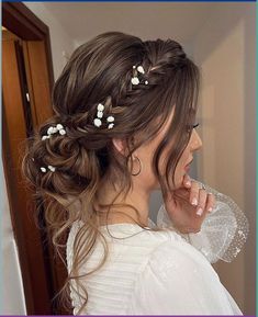 a woman with long hair and flowers in her hair is looking at herself in the mirror