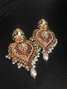 Your jewelry box is waiting for more items now! Shop these beautiful and party wear Multi stones navratna earrings and complete your formal look! Pre-order shipping time 3-4 weeks. Hyderabadi Jewelry, Simple Necklace Designs, Pakistani Earrings, Sabyasachi Jewellery, Antique Jewellery Designs, Antique Bridal Jewelry, Jewelry Set Design, Silver Jewellery Indian, Bangles Jewelry Designs