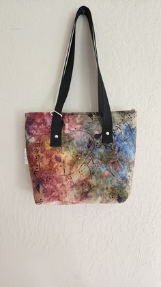 "A women's batik tote bag with leaves printed on multicolored fabric tote bag with recessed zipper and inner pocket. A handmade tote bag/fabric tote bag that is made out of batik fabric. A handbag perfect for everyday use, an everyday tote bag! A personalized tote bag perfect for your essentials like wallet, car keys or for water bottles and cosmetics. This tote bag can be used as a travel tote bag or a work, school or as a Christmas gift for your loved ones! This batik bag measures approximately 9\" x 3\" x 9\" (l,w,h) ** CARE INSTRUCTION: -DO NOT WASH ** DISCLAIMER: -NO RETURN OR EXCHANGE Please see Etsy policies for more information **SUPPORT US BY FOLLOWING OUR SOCIALS: - YOUTUBE - PINTEREST:  https://www.pinterest.com/DIY_SEWING_CRAFTS/ - TIKTOK: https://www.tiktok.com/@diysewingcraft Everyday Hand Dyed Cotton Bags, Colorful Cotton Bags For Everyday Use, Everyday Hand Dyed Tote Bag, Everyday Hand-dyed Tote Bag, Hand Dyed Rectangular Bags For Daily Use, Handmade Multicolor Canvas Bags, Multicolor Fabric Tote Canvas Bag, Multicolor Canvas Tote Bag, Multicolor Reversible Canvas Bag