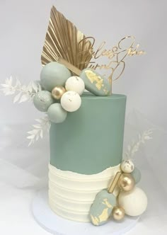 a blue and white cake with gold decorations