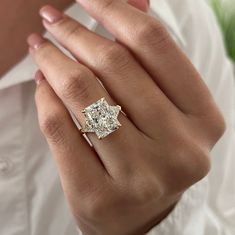 a woman's hand with a diamond ring on it