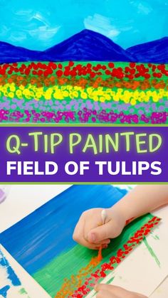 a child's hand is painting on a piece of paper with the words q - tip painted over it