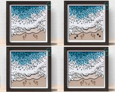 four framed artwork pieces with blue and white designs on the bottom, one depicting an ocean scene