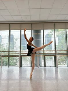 a ballerina is practicing in an empty room