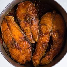 some chicken is cooking in a pan on the stove top with text overlay that reads vietnamese caramelized salmon