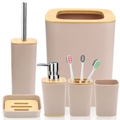 an assortment of bathroom accessories including toothbrushes, soap dispenser and cup