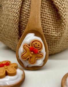 a wooden spoon sitting on top of a table next to cookies and other items in front of a burlap bag