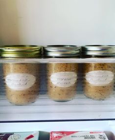 jars filled with food sitting on top of a refrigerator