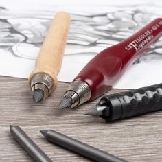 three different types of pens and pencils on a table