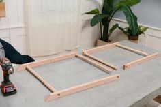 a table that has some tools on top of it and a plant in the background