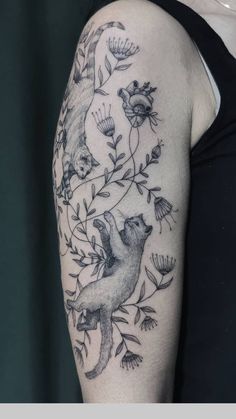 a woman's arm with an animal and flowers tattoo on it