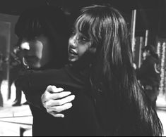 black and white photograph of two women hugging each other