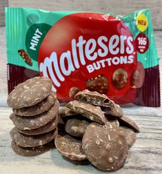 a bag of mates buttons next to some chocolate chips and a packet of reeses