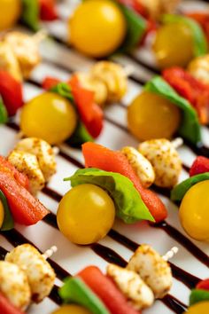 skewered vegetables and olives on a grill