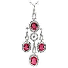 This eye-catching Art Deco style necklace features a beautiful collection of sparkling rubellite tourmaline ovals weighing 14.23 carats total! Over 3.50 carats of brilliant, pave-set diamonds frame the bright pink gems and adorn the various shapes that come together to form this elegant piece. Crafted in 18k white gold, this gorgeous pendant measures approximately 3 inches in length. With the included 18-inch, 18k white gold chain, the bottom of the pendant will sit where a 24-inch chain would s Rubellite Tourmaline, White Gold Sapphire, Pink Gem, Drop Pendant Necklace, Dangle Necklaces, Tourmaline Necklace, Modern Necklaces, Estilo Art Deco, Ring Pendant Necklace