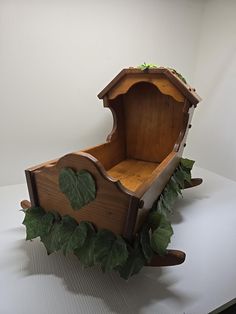 a wooden toy house with ivy growing around it